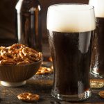 vaso de cerveza obscura con pretzels